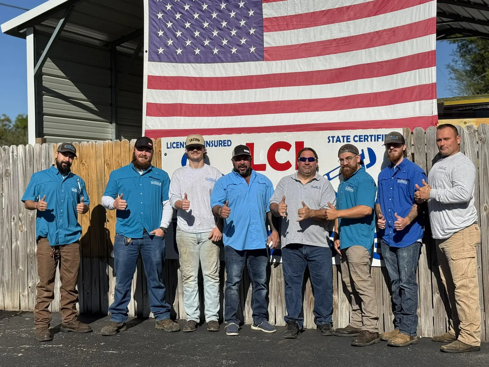 The LCI Plumbing & Septic crew outside the shop